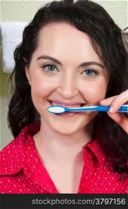 Beautiful woman practicing good oral dental care by brushing her teeth