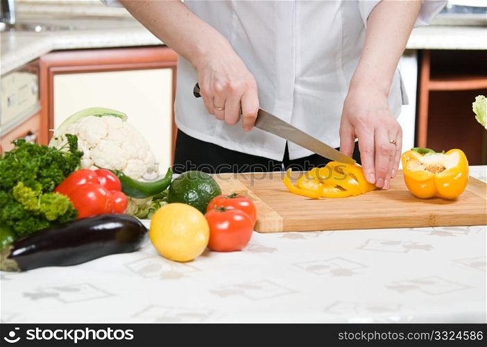 beautiful woman prepares food in the kitchen