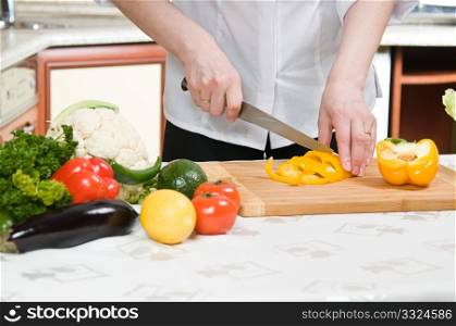 beautiful woman prepares food in the kitchen