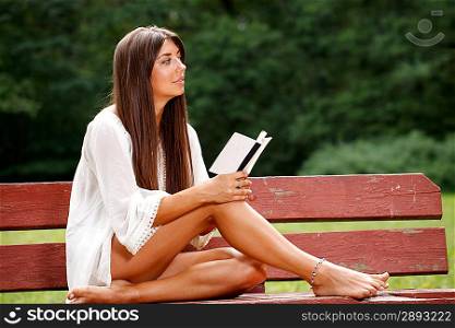 Beautiful woman reading small book