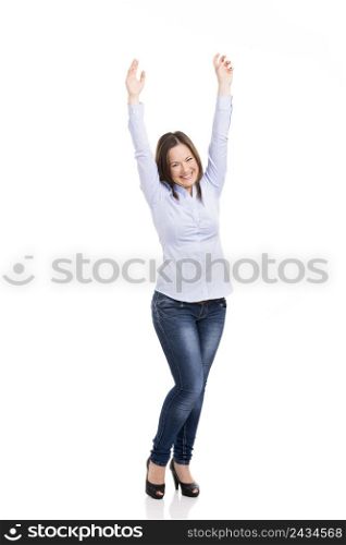Beautiful woman really happy with both arms on the air, isolated over white background
