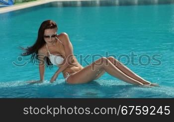 Beautiful woman relaxing in a pool on vacation