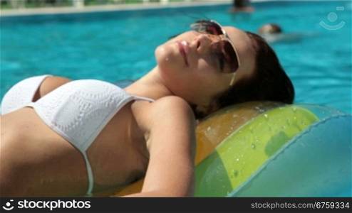 Beautiful Woman Relaxing In Pool on Vacation