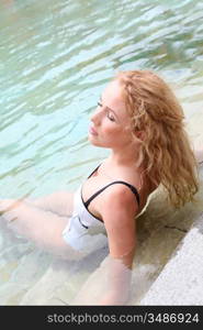 Beautiful woman relaxing in swimming pool