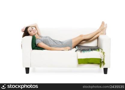 Beautiful woman relaxing on a sofa, isolated over a white background