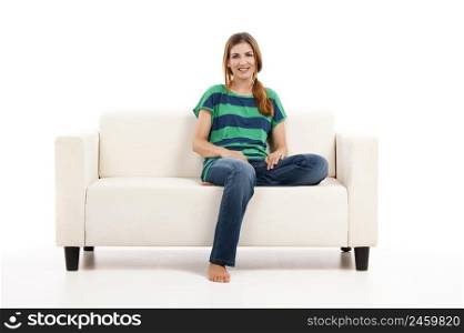 Beautiful woman relaxing on a white sofa with a cup of coffee