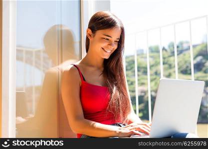 Beautiful woman relaxing with a computer