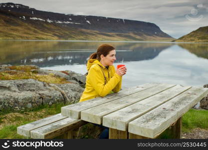 Beautiful woman resting close to a beautiful lake