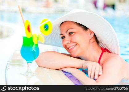 beautiful woman resting on the edge of the pool