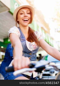 Beautiful woman riding on bike. Beautiful young woman riding on bike in city