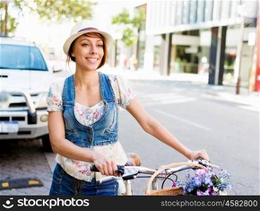 Beautiful woman riding on bike. Beautiful young woman riding on bike in city
