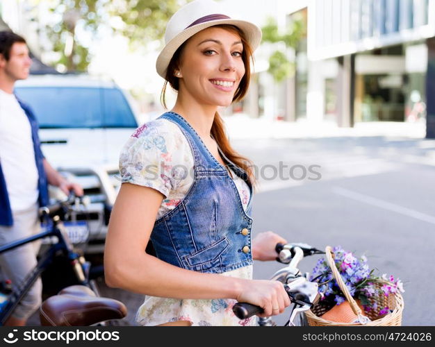 Beautiful woman riding on bike. Beautiful young woman riding on bike in city