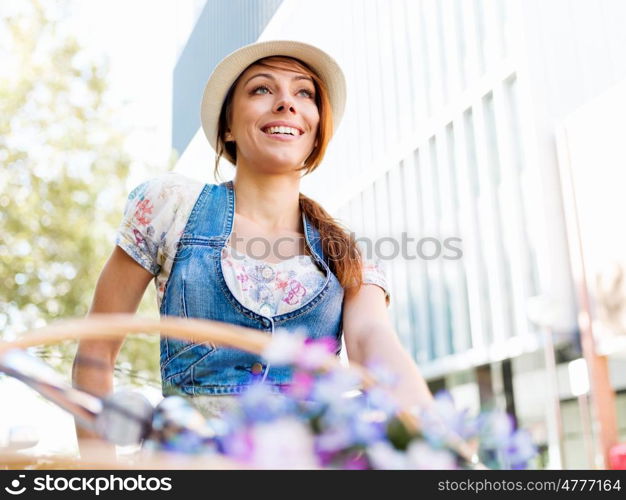 Beautiful woman riding on bike. Beautiful young woman riding on bike in city