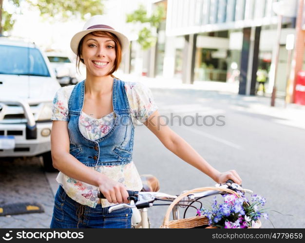 Beautiful woman riding on bike. Beautiful young woman riding on bike in city