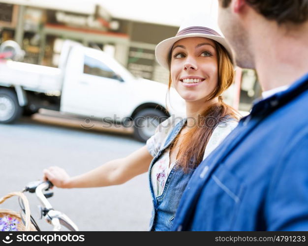 Beautiful woman riding on bike. Beautiful young woman riding on bike in city