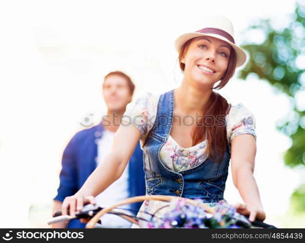 Beautiful woman riding on bike. Beautiful young woman riding on bike in city