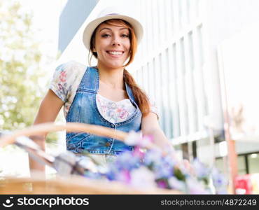 Beautiful woman riding on bike. Beautiful young woman riding on bike in city