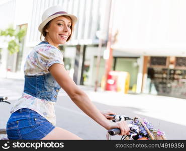 Beautiful woman riding on bike. Beautiful young woman riding on bike in city