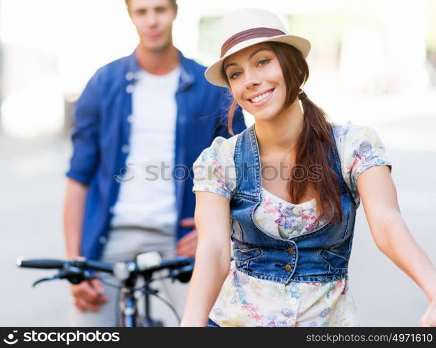 Beautiful woman riding on bike. Beautiful young woman riding on bike in city