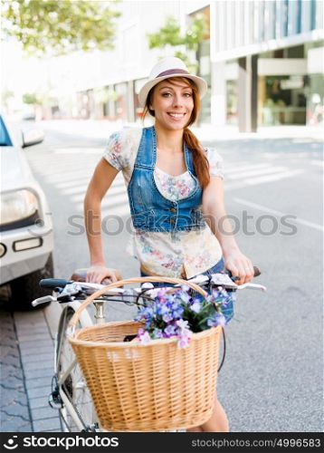 Beautiful woman riding on bike. Beautiful young woman riding on bike in city