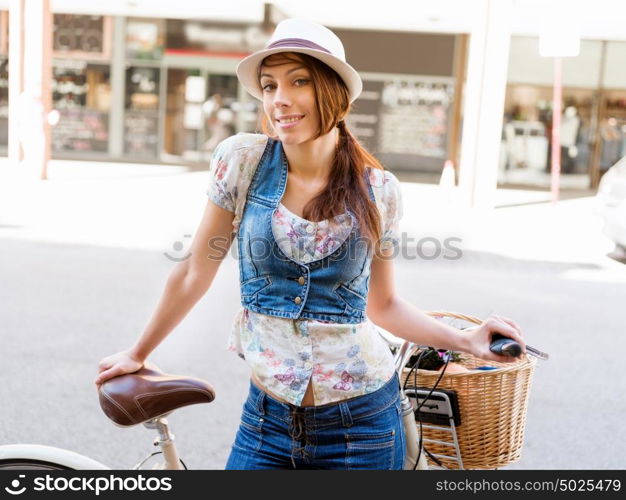 Beautiful woman riding on bike. Beautiful young woman riding on bike in city