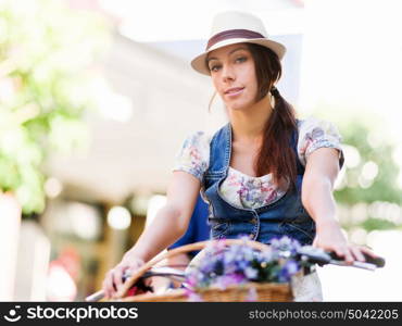 Beautiful woman riding on bike. Beautiful young woman riding on bike in city