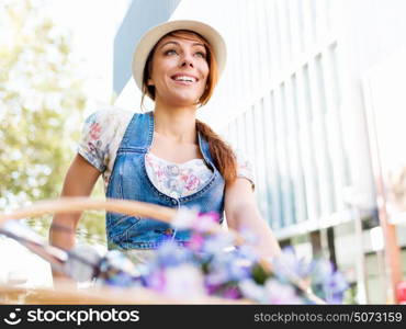 Beautiful woman riding on bike. Beautiful young woman riding on bike in city