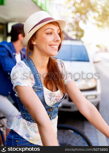 Beautiful woman riding on bike. Beautiful young woman riding on bike in city