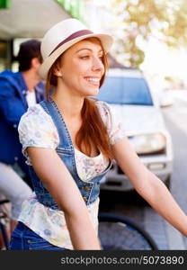 Beautiful woman riding on bike. Beautiful young woman riding on bike in city