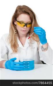 Beautiful woman scientist investigating a glass beaker