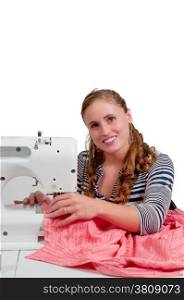 Beautiful woman seamstress with a sewing machine