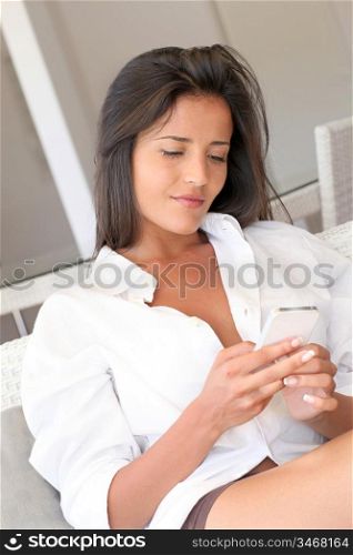 Beautiful woman sending message with mobile phone