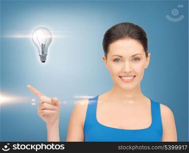 beautiful woman showing light bulb on her hand