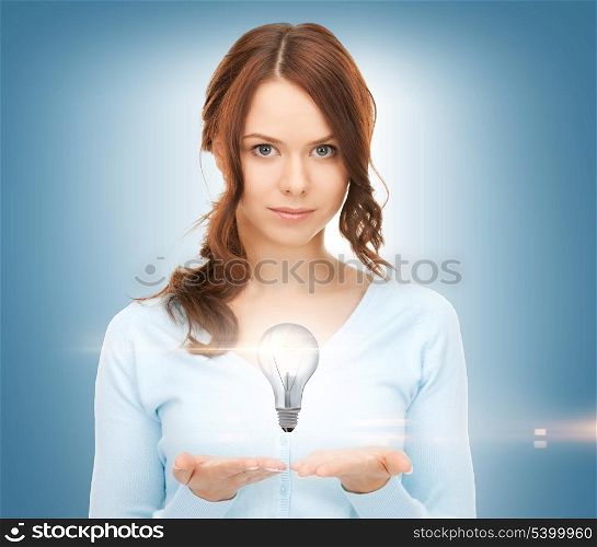 beautiful woman showing light bulb on her hands