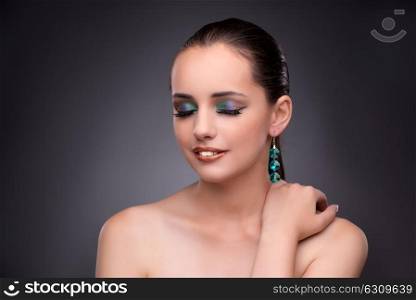Beautiful woman showing off her jewellery in fashion concept