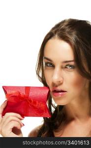 beautiful woman showing red present. beautiful woman showing red present near her face on white background