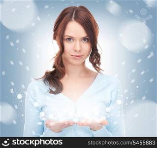 beautiful woman showing snow on the palm of her hand