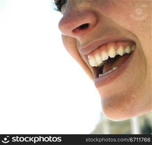 Beautiful woman shows off her pearly whites against a white background