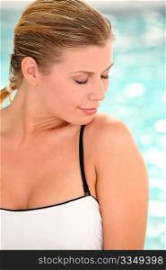 Beautiful woman sitting in swimsuit in spa resort