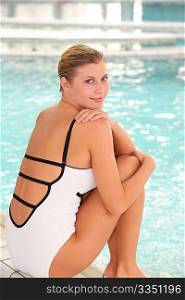 Beautiful woman sitting in swimsuit in spa resort