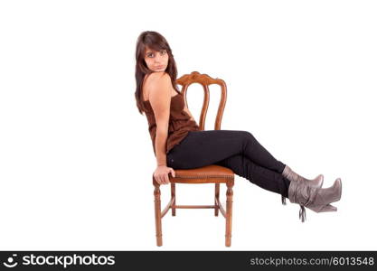 Beautiful woman sitting on a chair, isolated