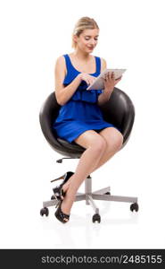 Beautiful woman sitting on a chair working with a tablet, isolated over white background
