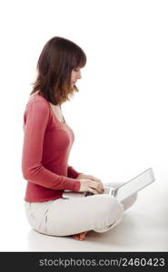 Beautiful woman sitting on the floor and working with a laptop