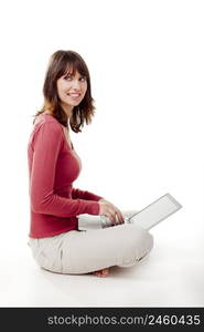 Beautiful woman sitting on the floor and working with a laptop