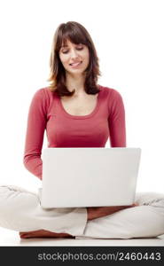 Beautiful woman sitting on the floor and working with a laptop