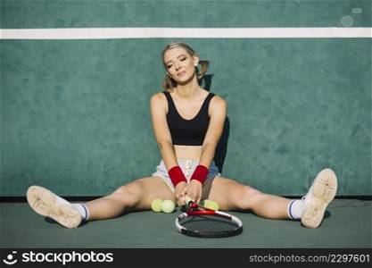 beautiful woman sitting tennis field