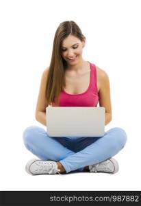 Beautiful woman sitting with crossed legs working with a laptop