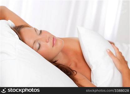 Beautiful woman sleeping in white bed, shallow DOF