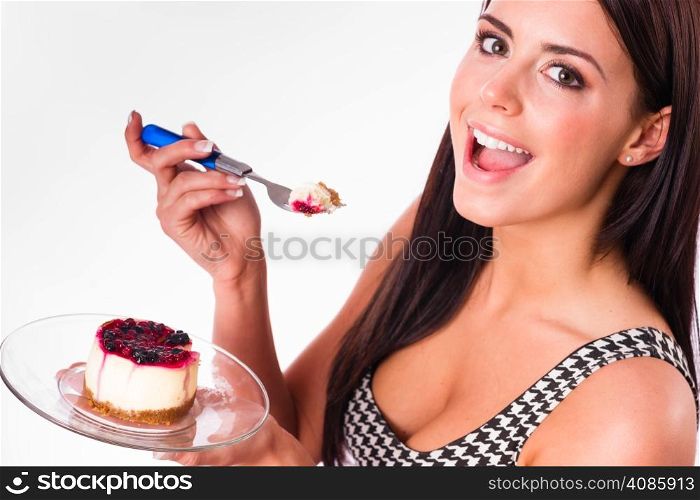 Beautiful woman smiles while eating cheesecake dessert