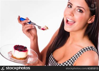 Beautiful woman smiles while eating cheesecake dessert